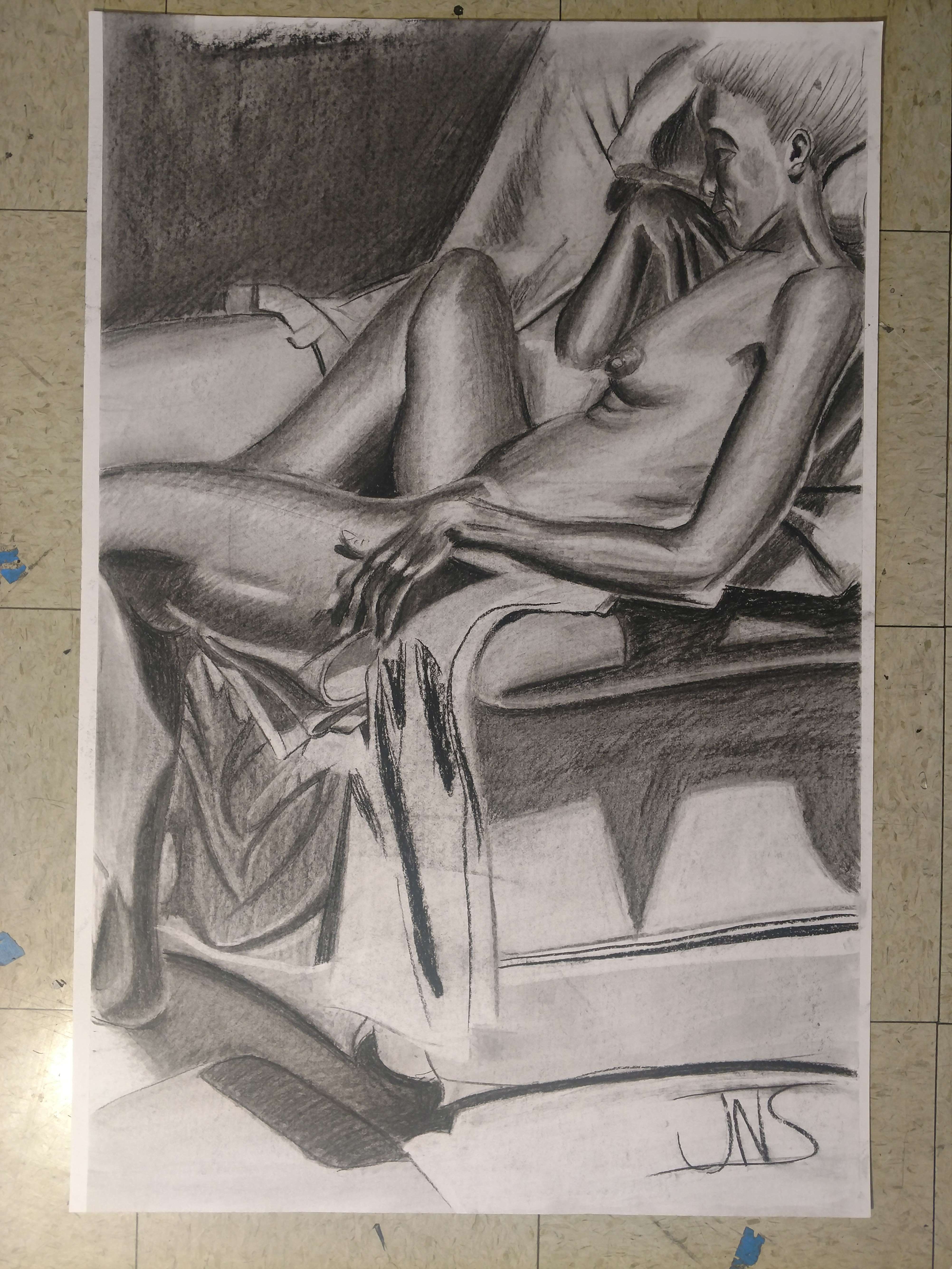 Charcoal illustration of a nude figure sitting in a chair thats facing to the left. The chair is draped in clothe with unfinished shading.